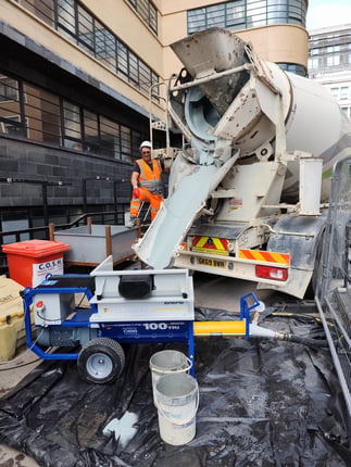 Euromair CP100 Electric Flow Screed Pump on site with ReadyMix Truck